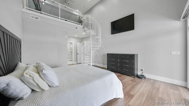 5450 Christopher Dr Unit 243, Osage Beach, MO 65065 - bedroom featuring a high ceiling and wood finished floors