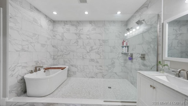 5450 Christopher Dr Unit 243, Osage Beach, MO 65065 - full bathroom featuring vanity, a freestanding bath, tiled shower, recessed lighting, and tile walls