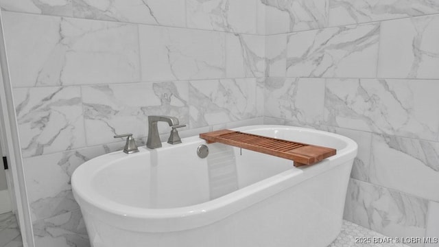 5450 Christopher Dr Unit 243, Osage Beach, MO 65065 - bathroom featuring tile walls, a freestanding bath, and marble finish flooring