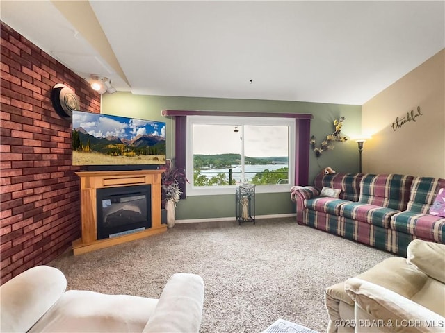 73 Good Neighbors Loop, Camdenton, MO 65020 - carpeted living room featuring brick wall and a glass covered fireplace