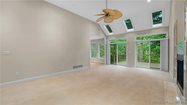 135 Greensboro Ct, Four Seasons, MO 65049 - unfurnished living room featuring a fireplace, carpet, ceiling fan, high vaulted ceiling, and a skylight