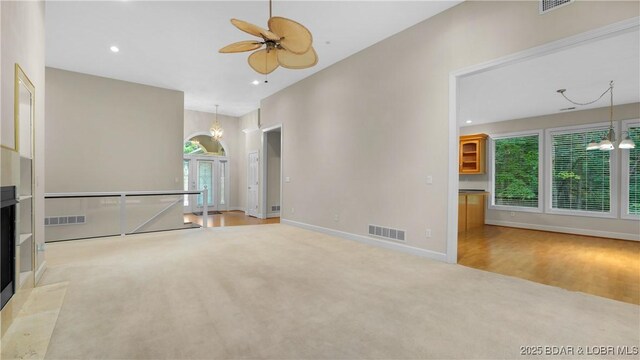 135 Greensboro Ct, Four Seasons, MO 65049 - unfurnished living room with carpet, ceiling fan, a chandelier, and recessed lighting