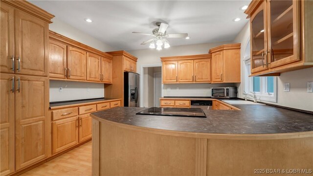 135 Greensboro Ct, Four Seasons, MO 65049 - kitchen featuring appliances with stainless steel finishes, glass insert cabinets, dark countertops, a peninsula, and recessed lighting