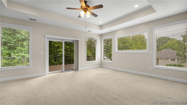 135 Greensboro Ct, Four Seasons, MO 65049 - empty room featuring a raised ceiling, light carpet, a ceiling fan, and recessed lighting