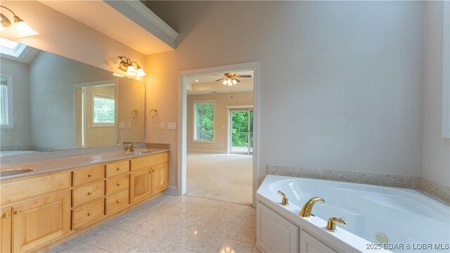 135 Greensboro Ct, Four Seasons, MO 65049 - bathroom featuring a whirlpool tub, double vanity, and a skylight