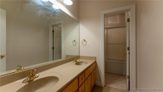 135 Greensboro Ct, Four Seasons, MO 65049 - bathroom featuring double vanity and tile patterned flooring