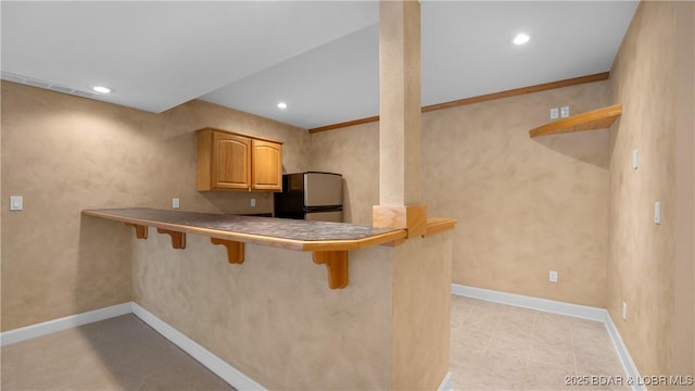 135 Greensboro Ct, Four Seasons, MO 65049 - kitchen with freestanding refrigerator, a breakfast bar area, recessed lighting, open shelves, and a peninsula