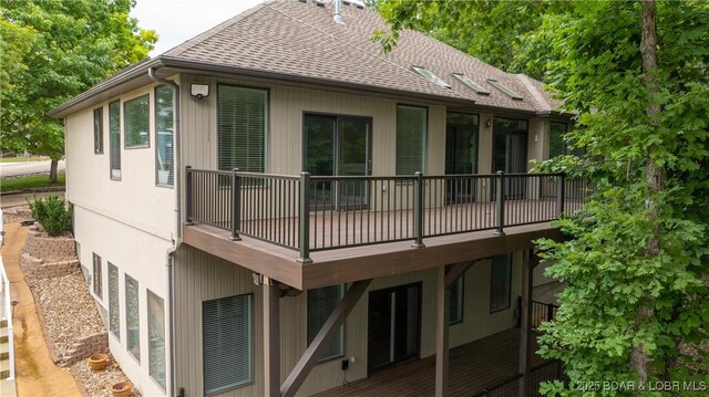 135 Greensboro Ct, Four Seasons, MO 65049 - rear view of house featuring roof with shingles and a deck