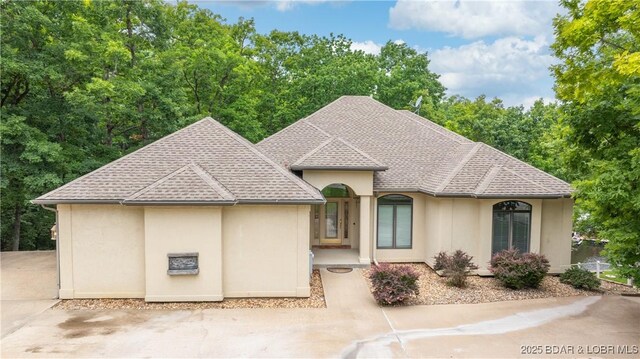 135 Greensboro Ct, Four Seasons, MO 65049 - view of front facade with stucco siding and roof with shingles