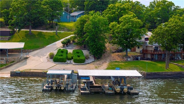 30383 Bullock Dr, Gravois Mills, MO 65037 - dock featuring boat lift, a water view, and a lawn