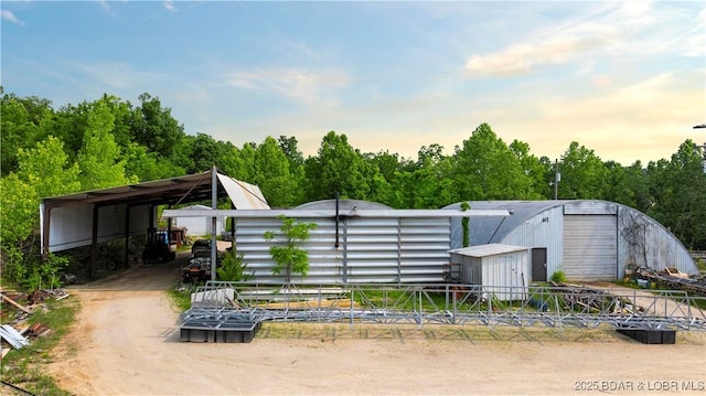 30383 Bullock Dr, Gravois Mills, MO 65037 - view of yard featuring an outdoor structure, an outbuilding, and a detached carport