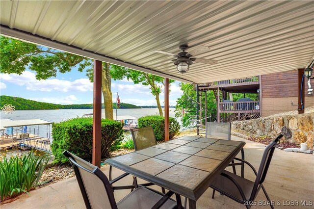30383 Bullock Dr, Gravois Mills, MO 65037 - view of patio / terrace featuring outdoor dining area, a water view, and a ceiling fan