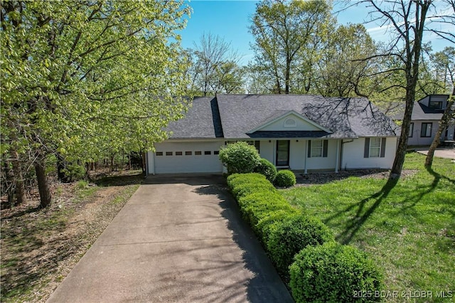 448 Cherokee Rd, Lake Ozark, MO 65049 - view of front of home featuring a garage, driveway, a front lawn, and a shingled roof