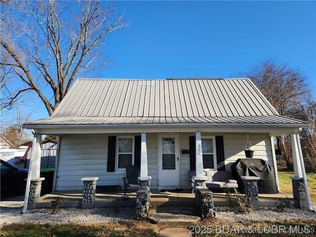 206 Oak St S, Versailles, MO 65084 - view of front of home featuring covered porch and a metal roof