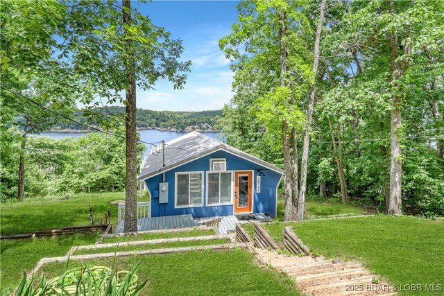 26794 Boone Rd, Barnett, MO 65011 - bungalow-style house with a front lawn and a water view