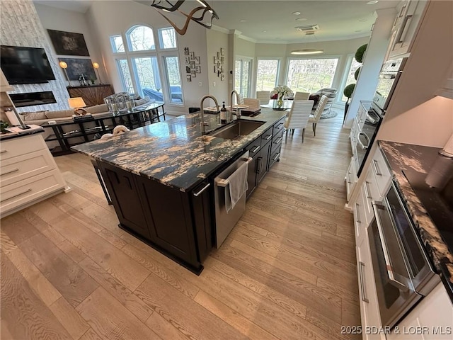 339 Cordoba Pt Unit 13B, Porto Cima, MO 65079 - kitchen with open floor plan, stainless steel appliances, light wood finished floors, and crown molding