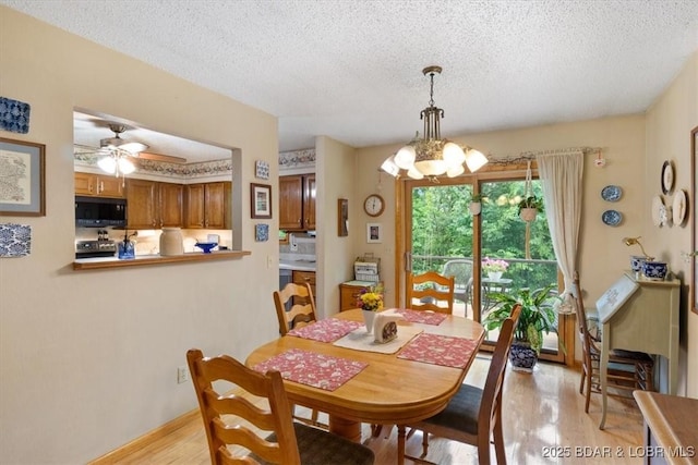 28 Wood River Rd, Lake Ozark, MO 65049 - dining space featuring light wood-style flooring, a textured ceiling, and a ceiling fan