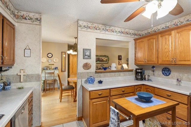 28 Wood River Rd, Lake Ozark, MO 65049 - kitchen with dishwasher, ceiling fan, light countertops, a textured ceiling, and brown cabinetry