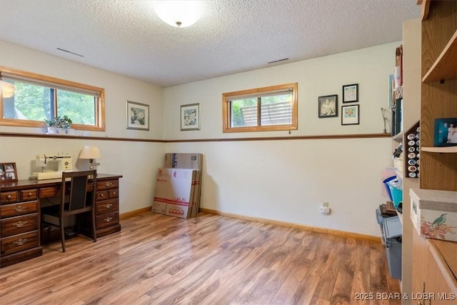28 Wood River Rd, Lake Ozark, MO 65049 - office area with wood finished floors, healthy amount of natural light, and a textured ceiling