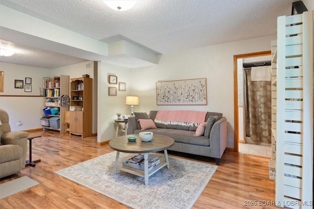 28 Wood River Rd, Lake Ozark, MO 65049 - living area with a textured ceiling and light wood-style floors