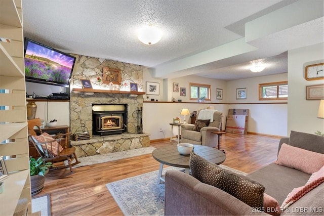 28 Wood River Rd, Lake Ozark, MO 65049 - living area with a textured ceiling, wood finished floors, and a stone fireplace