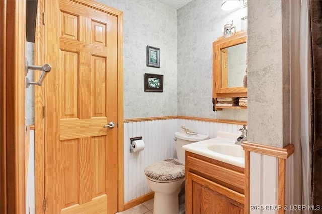 28 Wood River Rd, Lake Ozark, MO 65049 - half bath featuring vanity, wallpapered walls, tile patterned floors, and wainscoting