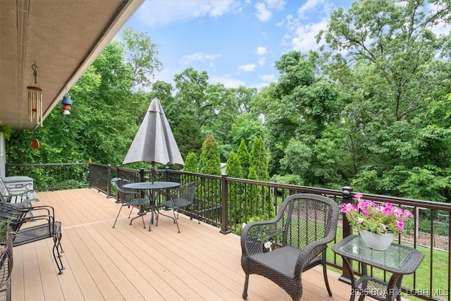 28 Wood River Rd, Lake Ozark, MO 65049 - wooden terrace with outdoor dining space and view of wooded area