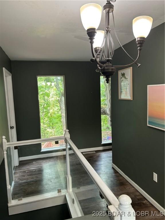121 Banner St, Camdenton, MO 65020 - stairway featuring healthy amount of natural light, a chandelier, and wood finished floors