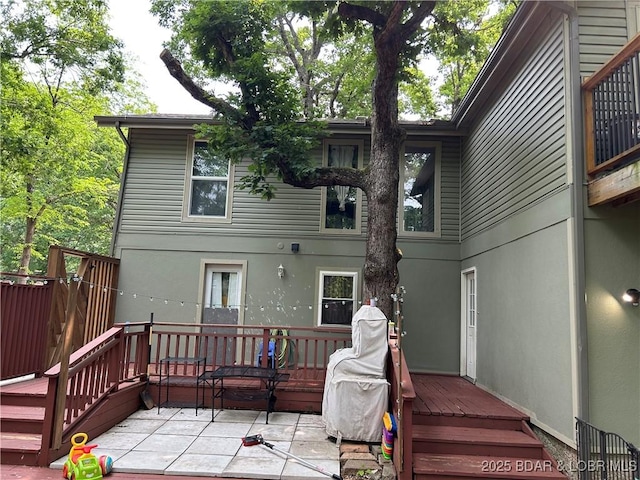 121 Banner St, Camdenton, MO 65020 - back of house with a deck, stucco siding, and a patio area