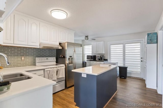 27638 Golden Point Ln, Barnett, MO 65011 - kitchen with appliances with stainless steel finishes, extractor fan, tasteful backsplash, white cabinets, and ceiling fan