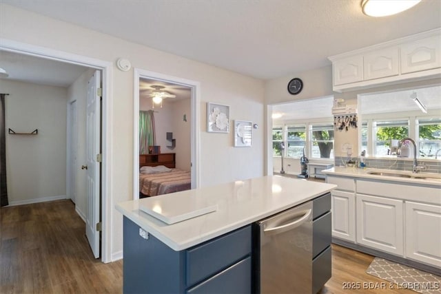 27638 Golden Point Ln, Barnett, MO 65011 - kitchen featuring white cabinetry, light countertops, wood finished floors, a kitchen island, and blue cabinets