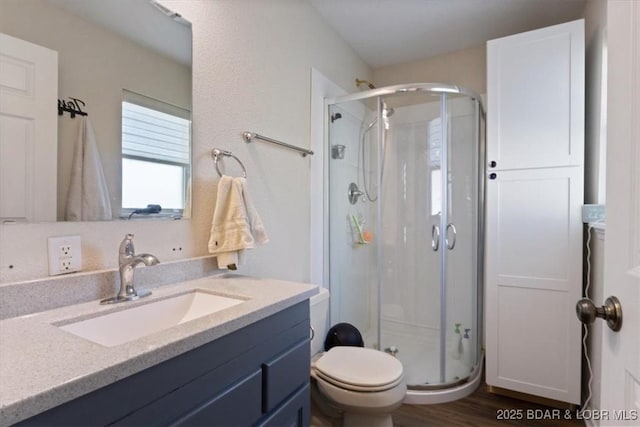 27638 Golden Point Ln, Barnett, MO 65011 - bathroom featuring a stall shower, vanity, and wood finished floors