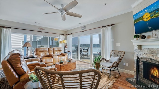183 Upper Monarch Cove Dr Unit 3D, Lake Ozark, MO 65049 - living area featuring a fireplace, wood finished floors, a ceiling fan, crown molding, and a water view