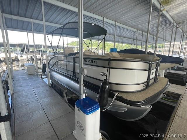 183 Upper Monarch Cove Dr Unit 3D, Lake Ozark, MO 65049 - view of vehicle parking with boat lift and a dock