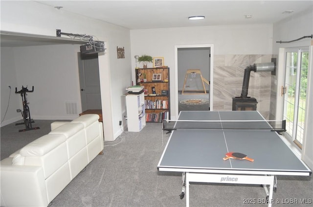21 Winston Ln, Kaiser, MO 65047 - game room with a wood stove and carpet flooring