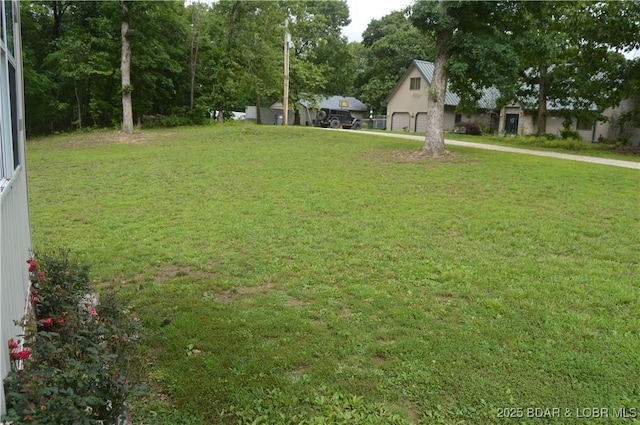 21 Winston Ln, Kaiser, MO 65047 - view of yard with an attached garage
