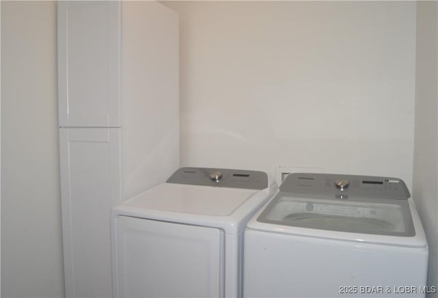 21 Winston Ln, Kaiser, MO 65047 - laundry room featuring washer and dryer and cabinet space