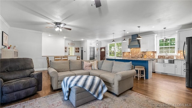 21 Winston Ln, Kaiser, MO 65047 - living area with ceiling fan, light wood finished floors, plenty of natural light, recessed lighting, and ornamental molding