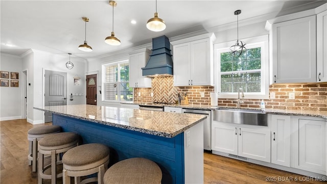 21 Winston Ln, Kaiser, MO 65047 - kitchen with premium range hood, appliances with stainless steel finishes, ornamental molding, light wood-type flooring, and decorative backsplash