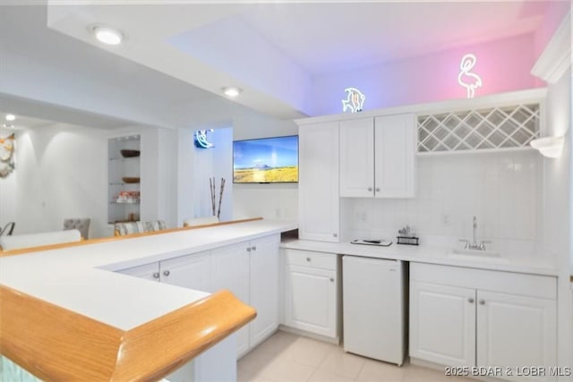 26 Port Bagnell Rd, Eldon, MO 65026 - kitchen featuring a peninsula, light countertops, white cabinets, light tile patterned floors, and dishwashing machine