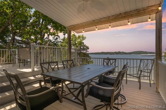 26 Port Bagnell Rd, Eldon, MO 65026 - deck at dusk featuring outdoor dining area and a water view