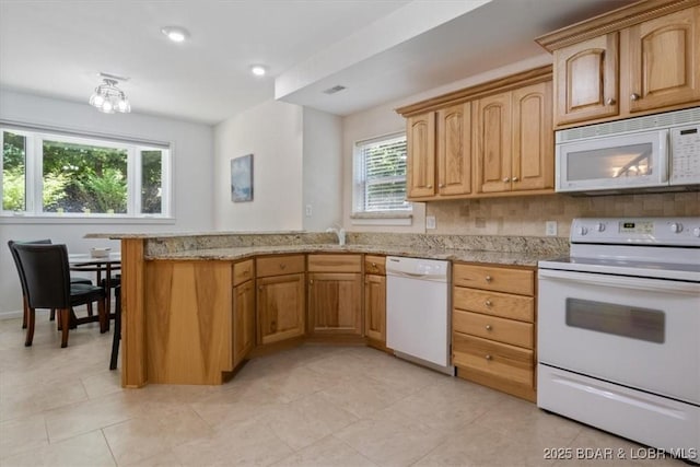 26 Port Bagnell Rd, Eldon, MO 65026 - kitchen featuring white appliances, plenty of natural light, a peninsula, light stone counters, and recessed lighting