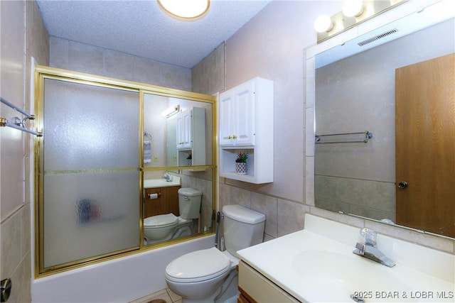 1442 Nichols Rd Unit D301, Osage Beach, MO 65065 - bathroom featuring tile walls, bath / shower combo with glass door, and vanity