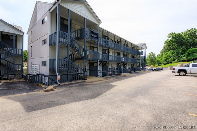 1442 Nichols Rd Unit D301, Osage Beach, MO 65065 - view of apartment building / complex featuring stairway and uncovered parking