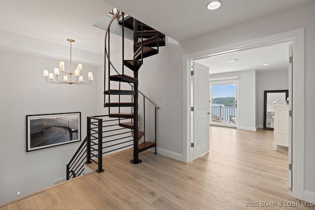 584 Black Hawk Dr, Lake Ozark, MO 65049 - staircase featuring wood finished floors, a chandelier, and recessed lighting