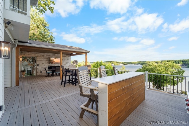 584 Black Hawk Dr, Lake Ozark, MO 65049 - wooden deck featuring outdoor dining area and a water view