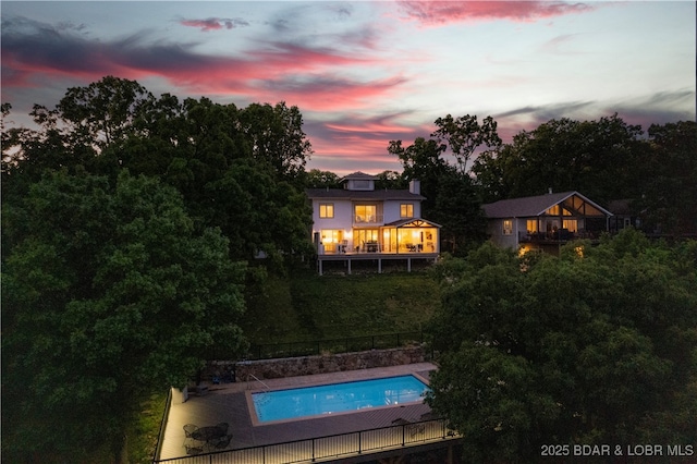 584 Black Hawk Dr, Lake Ozark, MO 65049 - back of house at dusk with a balcony