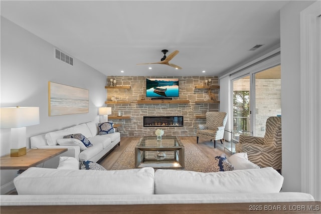 584 Black Hawk Dr, Lake Ozark, MO 65049 - living room with wood finished floors, ceiling fan, a fireplace, and recessed lighting