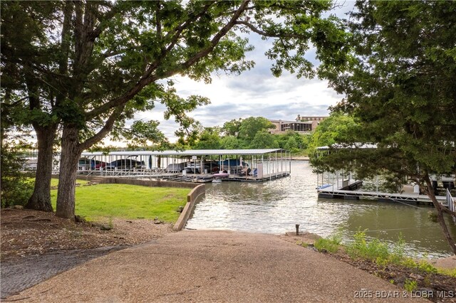 584 Black Hawk Dr, Lake Ozark, MO 65049 - dock area featuring a water view and a lawn