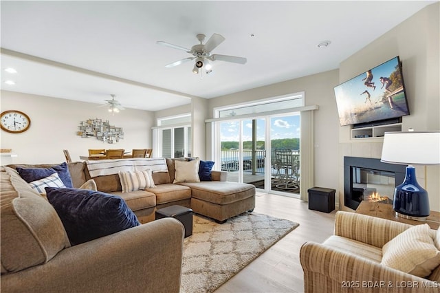 5450 Christopher Ln Unit 211, Osage Beach, MO 65065 - living area featuring ceiling fan, light wood-style flooring, a tile fireplace, and recessed lighting